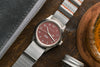 Overhead shot of the Oak & Oscar Olmsted FEW limited edition sitting on wood board with grey nylon strap